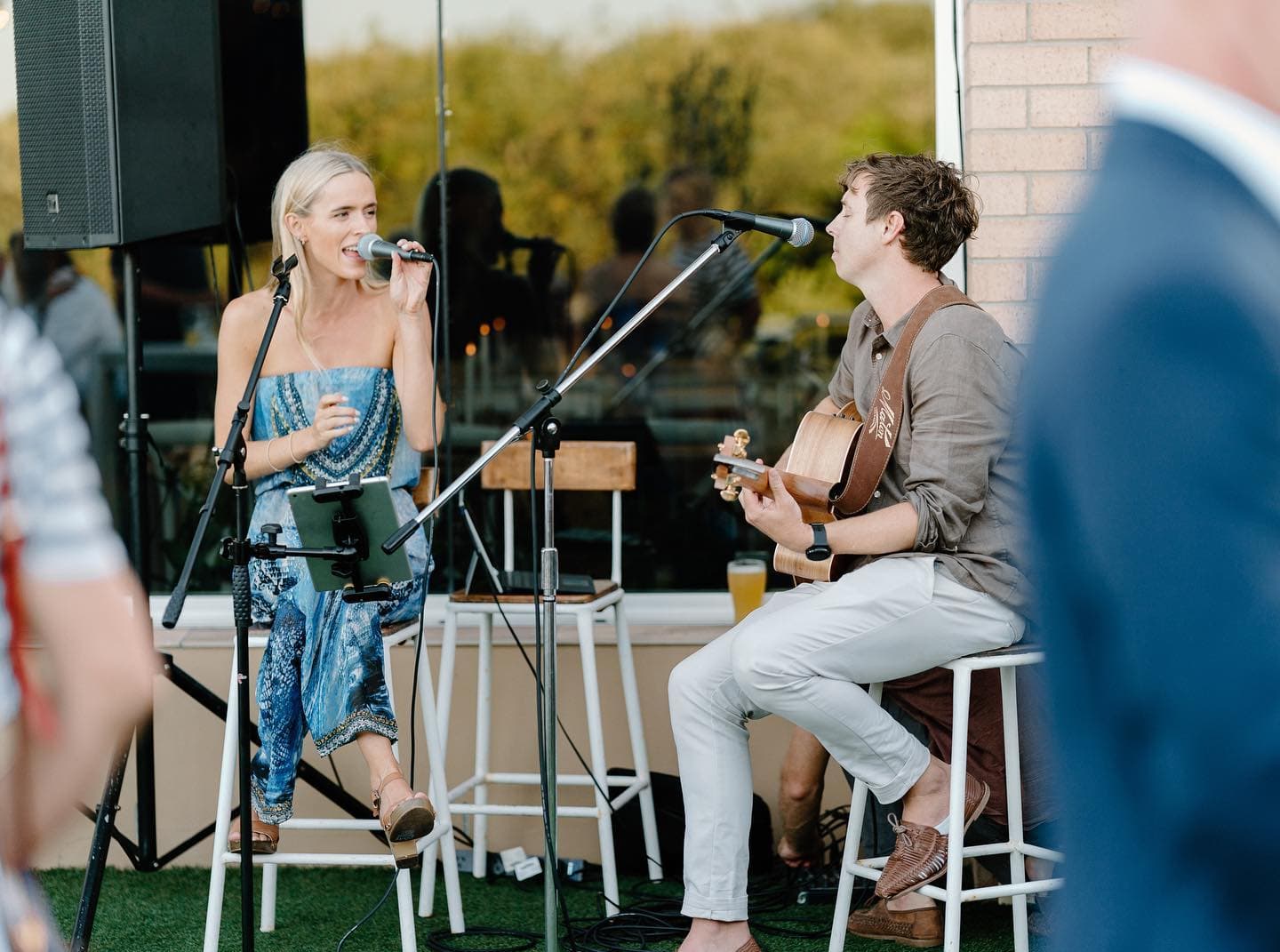 Blue Vinyl acoustic duo performing at an outdoor event, vocalist and guitarist