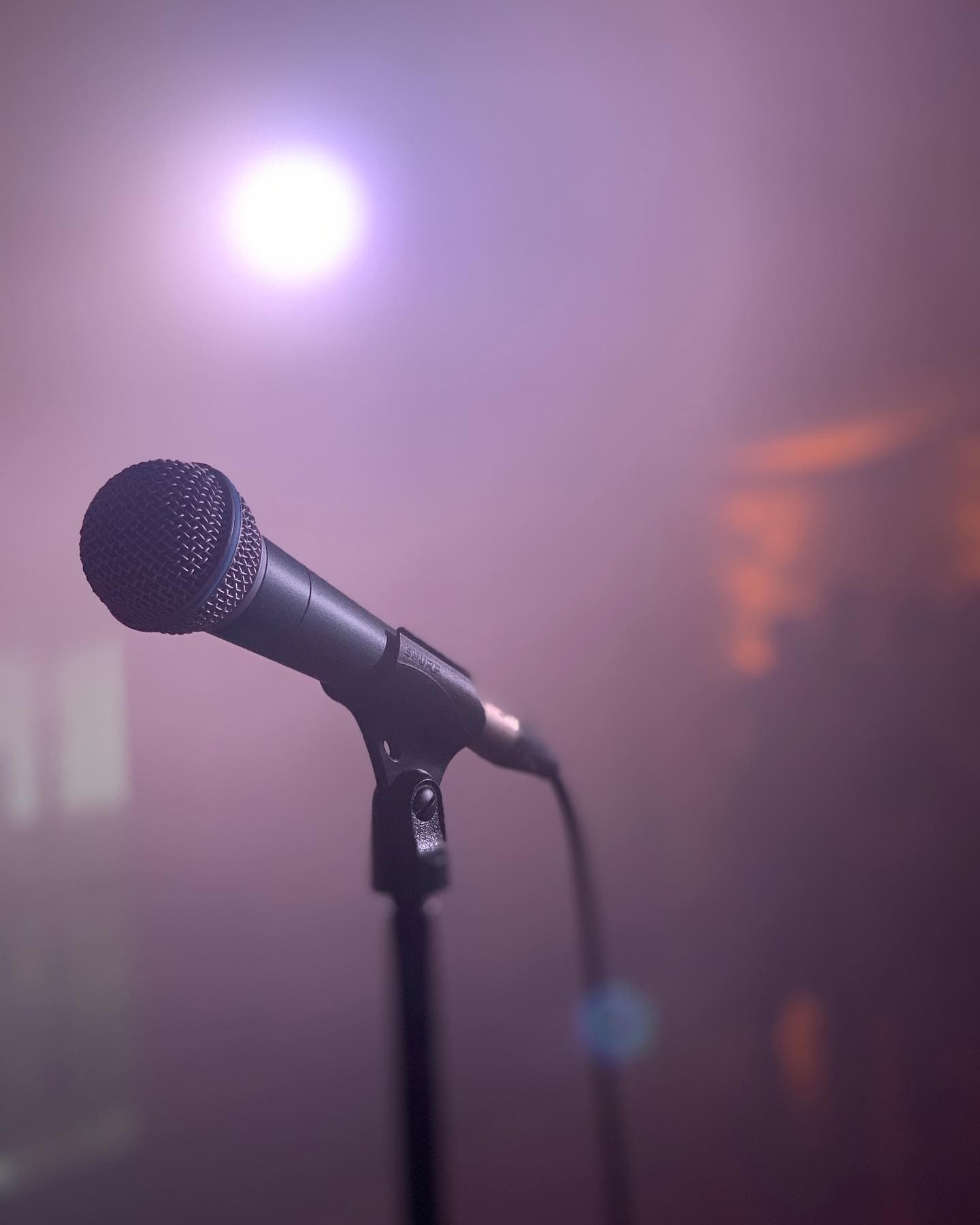 Microphone on stage with atmospheric lighting before a Blue Vinyl performance