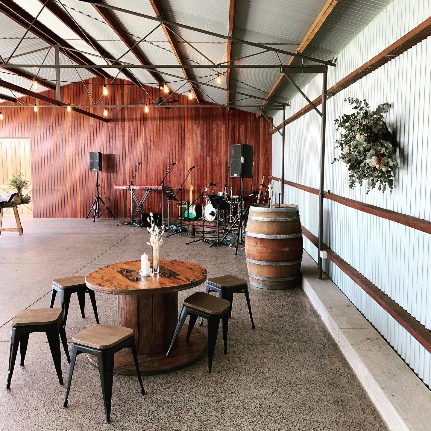 Rustic barn wedding venue with Blue Vinyl stage setup and fairy lights, Central Coast NSW